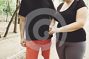 Overweight couple walking together in park