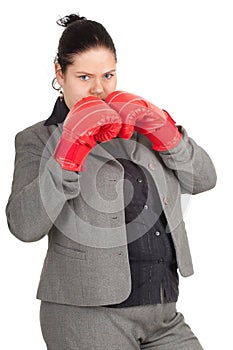 Overweight, fat businesswoman in boxing gloves