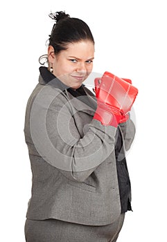 Overweight, fat businesswoman in boxing gloves