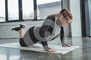 Overweight girl doing push ups