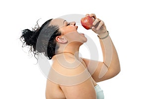 Overweight girl eating red apple.