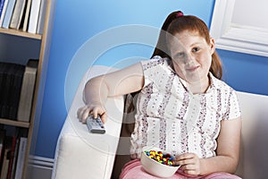 Overweight Girl With Remote Control Eats Junk Food On Couch