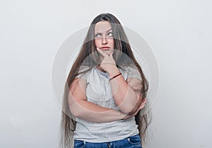 Overweight girl thought, propped her head up with hand