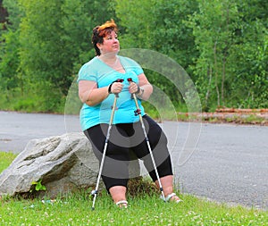 Overweight hiker woman relaxing.