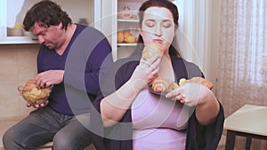 Overweight husband and wife eat at night not healthy food forgetting about the diet. Overweight family on a diet. Proper
