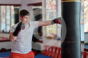 Overweight kickboxer working the heavy bag