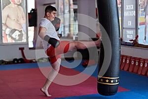 Overweight kickboxer working the heavy bag