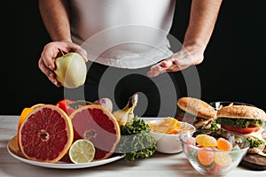 Overweight man choosing healthy refusing junk food