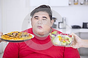 Overweight man confusing to choose foods