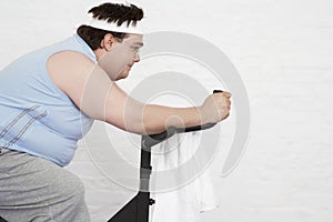 Overweight Man On Exercise Bike