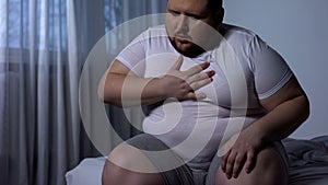 Overweight man feeling chest pain, health body care, heart attack, dyspnea