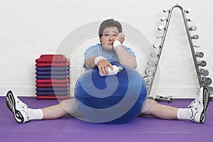 Overweight Man On Floor With Exercise Ball