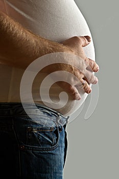 Overweight man with hand on belly