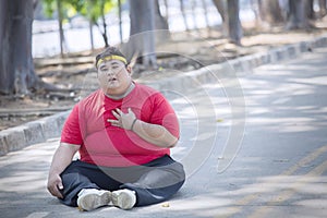 Overweight man having heart pain after exercising