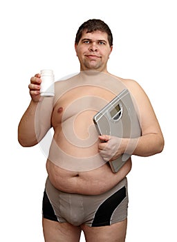 Overweight man with medicaments and scales