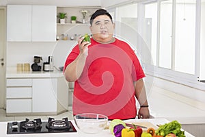 Overweight man preparing to make a tasty salad