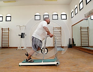 Overweight man running on trainer treadmill