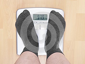 Overweight man on scales