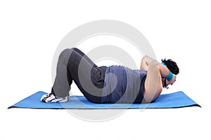 Overweight man working out on mattress