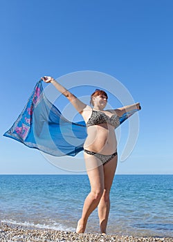 Overweight middle aged woman at the sea