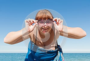 Overweight middle aged woman at the sea