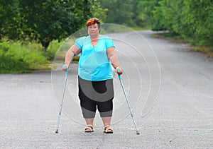Overweight patient with crutches.