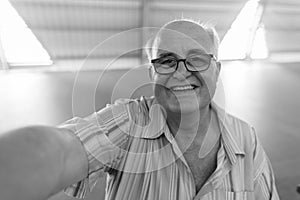 Overweight senior tourist man exploring around the city of Bangkok, Thailand