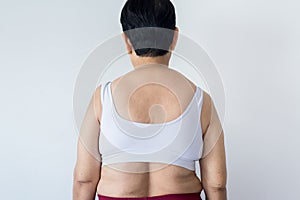 Overweight senior woman pinching her fat body,Cellulite,squeezing her belly fat around her back,Healthy lifestyle concept