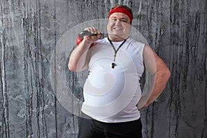 Overweight sportive man shows his strength and competence