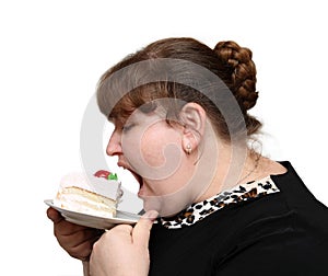 Overweight woman biting cake