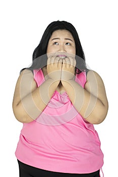 Overweight woman biting her fingernails