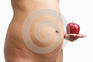 Overweight woman body holding apple