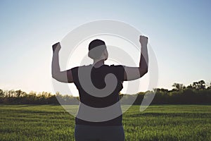 Overweight woman celebrating rising hands to sky