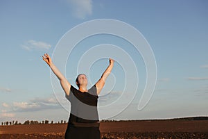 Overweight woman celebrating rising hands to sky