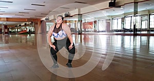 Overweight woman dancing in dance hall