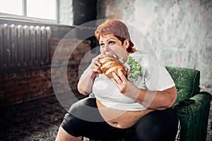 Overweight woman eats sandwich, bulimic