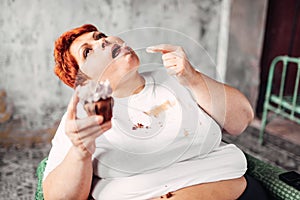 Overweight woman eats sweet cake, obesity