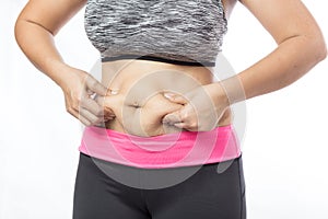 Overweight woman hand pinching excessive belly fat