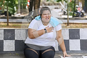 Overweight woman having heart attack at park