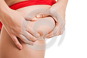 Overweight woman holding or pinching fat body bottom or buttocks