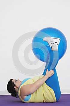 Overweight Woman Holding up Exercise Ball With Legs