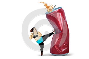 Overweight woman kicking soft drink