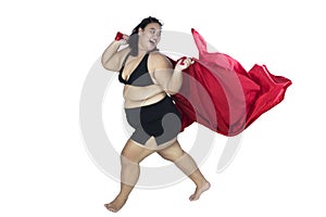 Overweight woman posing with a red fabric