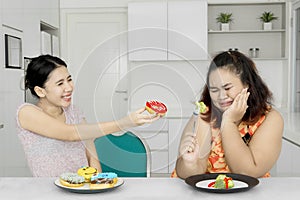 Overweight woman refuses to eat donuts