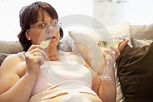 Overweight Woman Relaxing On Sofa