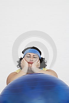 Overweight Woman Sitting Behind Exercise Ball