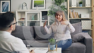 Overweight woman talking to therapist and smiling during consultation in clinic