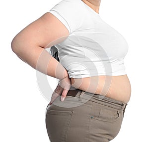 Overweight woman in tight t-shirt and trousers on white background, closeup