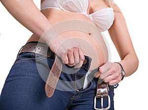 Overweight woman trying to wear jeans