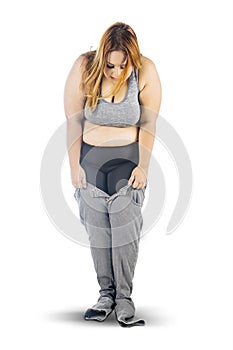 Overweight woman trying to wear small jeans